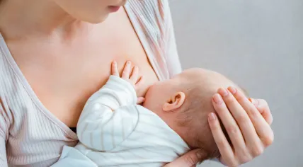 A mother breast feeds her baby.