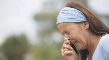A woman sneezes.
