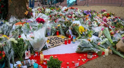 Flowers and candles left at the scene of a mass shooting on 24 Oktoberplein in Utrecht on 18 March 2019