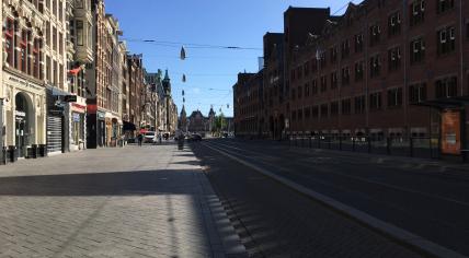 Completely empty at morning rush hour: The Damrak in Amsterdam Centrum during the coronavirus pandemic. May 28, 2020