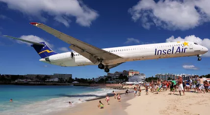 Insel Air plane passing low over Maho Beach as it approaches Princess Juliana airport on Sint Maarten, January 2013