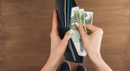 Woman with a wallet full of euros