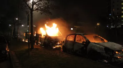 Second_day_of_Husby_riots,_three_burning_cars