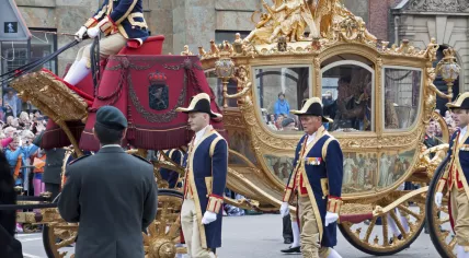 Queen Maxima sitting alongside King Willem-Alexander in the back of the Golden Carriage on Budget Day in 2015