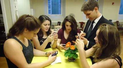 Young_people_texting_on_smartphones_using_thumbs