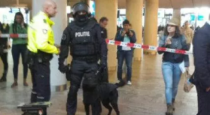 Police officer and police dog on Rotterdam Central Station to deal with a suspicious passenger who locked himself into a Thalys train bathroom