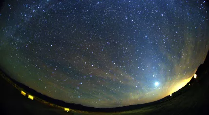 Two meteors streak across the sky during the 2007 Orionid meteor shower. Oct. 22, 2007