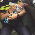 Tilburg cop feeds baby at the scene of an accident on the N269, 24 May 2017