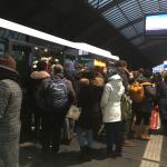 Bus riders try to jam into Bus 48 to Houthavens at Amsterdam Centraal, 11 Dec 2017