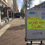 Covid-19: Handwritten sign advertising hand sanitizer, masks for sale in Amsterdam, 16 April 2020