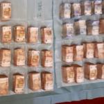 Bundles of cash: Part of a 2.4 million euro find inside a home in Amsterdam Oost