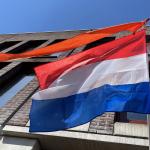 The Dutch flag capped by an orange ribbon flies above a home in Amsterdam on King’s Day.  27 April 2021