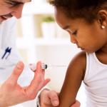 Doctor administering a vaccine to a child