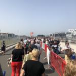 Passengers at Schiphol line up under the sun on a hot afternoon. 18 June 2022