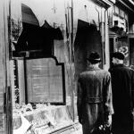 People in Berlin examine a storefront destroyed during Kristallnacht. 10 November 1938