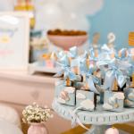 A selection of chocolate pops adorned in blue and pink designs at a baby shower