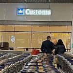 A Douane worker looking over documents at a Customs station in Schiphol Airport. 13 December 2022