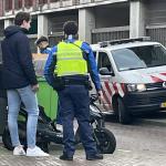 A special enforcement officer (BOA) addresses a situation on the street in Amsterdam-Oost. 31 December 2021