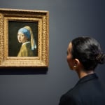 A Rijksmuseum visitor looks at Girl with a Pearl Earring at the Vermeer exhibition. February 2023