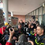 Amsterdam Mayor Femke Halsema, flanked by police officers in front of the Stopera, argues with sex workers angered about her policies regarding the Red Light District and the proposed erotic center. 30 March 2023