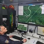 A rescue worker tracks the progress of the search for victims after a small plane crash involving Dutch victims at Mount Kapeli. 20 May 2023