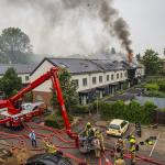 Firefighters fighting a fire in a housing block on Kinsbergenstraat in Arnhem, 18 June 2023