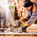 Carpenters using a circular saw in a workshop