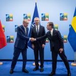 Turkish President Recep Tayyip Erdogan shaking hands with Swedish Prime Minister Ulf Kristersson in the presence of NATO Secretary General Jens Stoltenberg, 10 July 2023