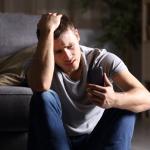 Unhappy man looking at his phone