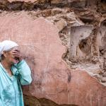 A woman reacts standing infront of her earthquake-damaged house in the old city in Marrakesh on September 9, 2023. 