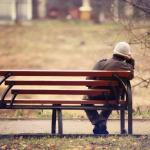 Lonely man sitting on a bench.