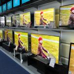 Wall of flat screen televisions in the electronics section of a store