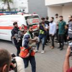 Medics transport injured Palestinian children into Al-Shifa hospital in Gaza City following an Israeli airstrike on 11 October 2023.