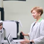 An ophthalmologist examines the eyes of a girl on modern equipment