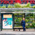 A bus stop in Eindhoven showing an advertisement for a travel agency