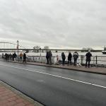 People walk past sandbag reinforcements on the Welle, a quay along the IJssel River, in Deventer. 27 December 2023