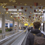 A passenger walking though Schiphol Airport during the Christmas 2023 holiday period