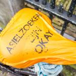 A cover on a bicycle in Amsterdam says, "Asylum seekers are okay". February 2014