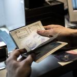 A Koninklijke Marechaussee officer doing a passport check