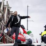 The police intervene after demonstrators climbed onto a van of the Mobile Unit on Waterlooplein.