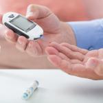 Diabetes. Stock photo of a man measuring his blood sugar levels