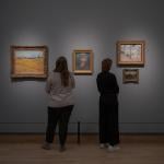 The Vincent van Gogh paintings Wheat Field (1888), Riverbank with Trees (1887), and View of Amsterdam from Central Station (1885) hanging with a self-portrait of the Dutch artist in the Rijksmuseum, March 2024