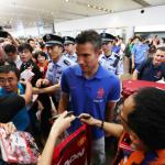 Dutch footballer Robin van Persie, center, is surrounded by Chinese fans at the Beijing Capital International Airport in Beijing, China.