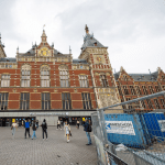 People walk past construction at the central rail station in Amsterdam. April 2024