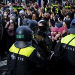 Riot police surround and arrest a group of pro-Palestinian demonstrators trying to reach a pro-Israel protest on Dam Square in Amsterdam, 27 May 2024