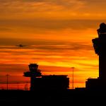 Plane landing at Schiphol Airport at sunset