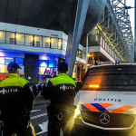 Police watching PSV fans leaving the celebration of their team's 25th Eredivisie title, 6 May 2024