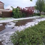 Piles of hail on a flooded street in Achtkarspelen, Friesland. 20 May 2024