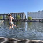 A boy jumps into the water from a pier in Amsterdam on the hottest day of the year to date. 27 June 2024