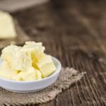 Pieces of Butter on wooden background